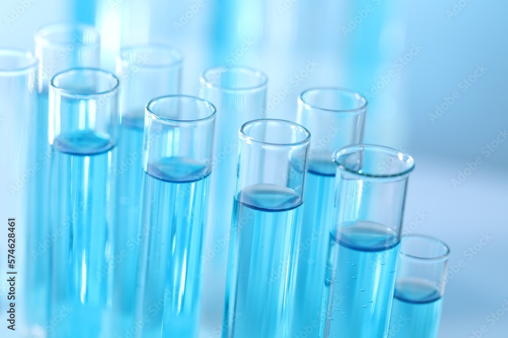 Test tubes with light blue liquid in laboratory, closeup Test tubes with light blue liquid in laboratory, closeup