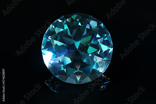 Beautiful dazzling diamond on black mirror background, closeup