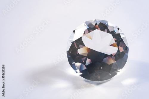 Beautiful dazzling diamond on white background  closeup. Space for text