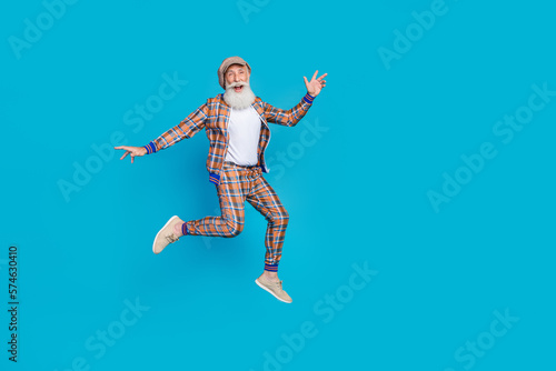 Photo of overjoyed man wear trendy outfit rejoice sale discounts new collection clothes empty space isolated on blue color background