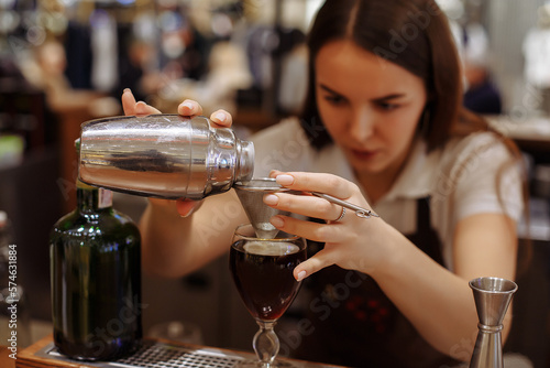 Two baristas work on creating coffee in a coffee shop