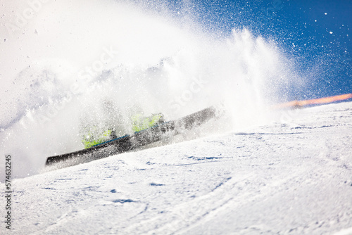 Alpine snowboarder crashing during race throwing up masses of snow