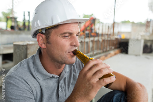 portrait of construction mason worker drinking beer