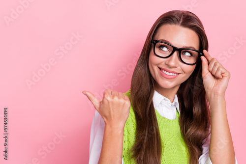 Fototapeta Naklejka Na Ścianę i Meble -  Photo of stunning clever lady arm demonstrates empty space recommend buy quality accessory eyeglasses isolated on pink color background