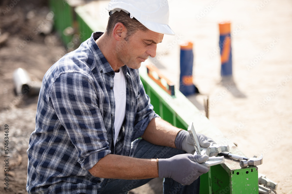 construction worker laying foundations in building construction worker laying foundations in building