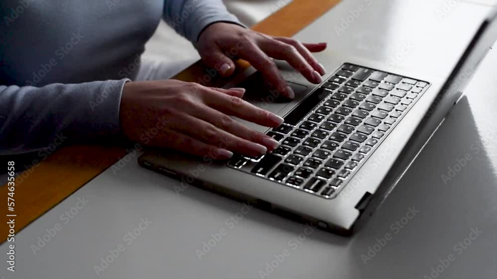 Female hands scrolling on the computer touchpad Female hands scrolling on the computer touchpad