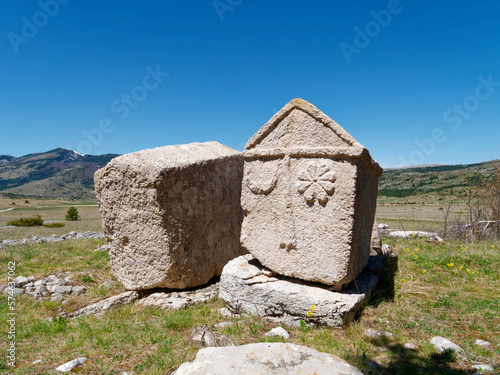 Stecci Medieval Tombstones Graveyards Risovac in Blidinje, BiH. Unesco site. Historic place of interest. The tombstones feature a wide range of decorative motifs and inscriptions. photo