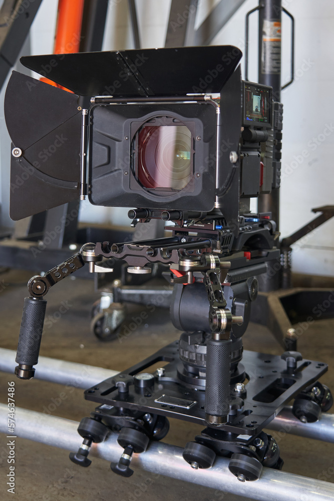 general view of a professional film camera, which stands on a camera trolley with wheels on rails general view of a professional film camera, which stands on a camera trolley with wheels on rails