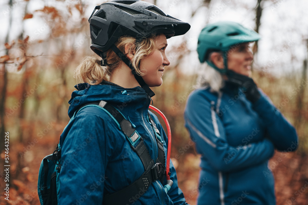 Smiling daughter and mother peparing to go mountain biking together Smiling daughter and mother peparing to go mountain biking together