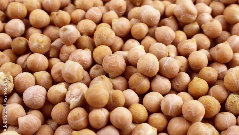 Yellow dried chickpeas or chick peas falling down with circle rotation close up Yellow dried chickpeas or chick peas falling down with circle rotation close up