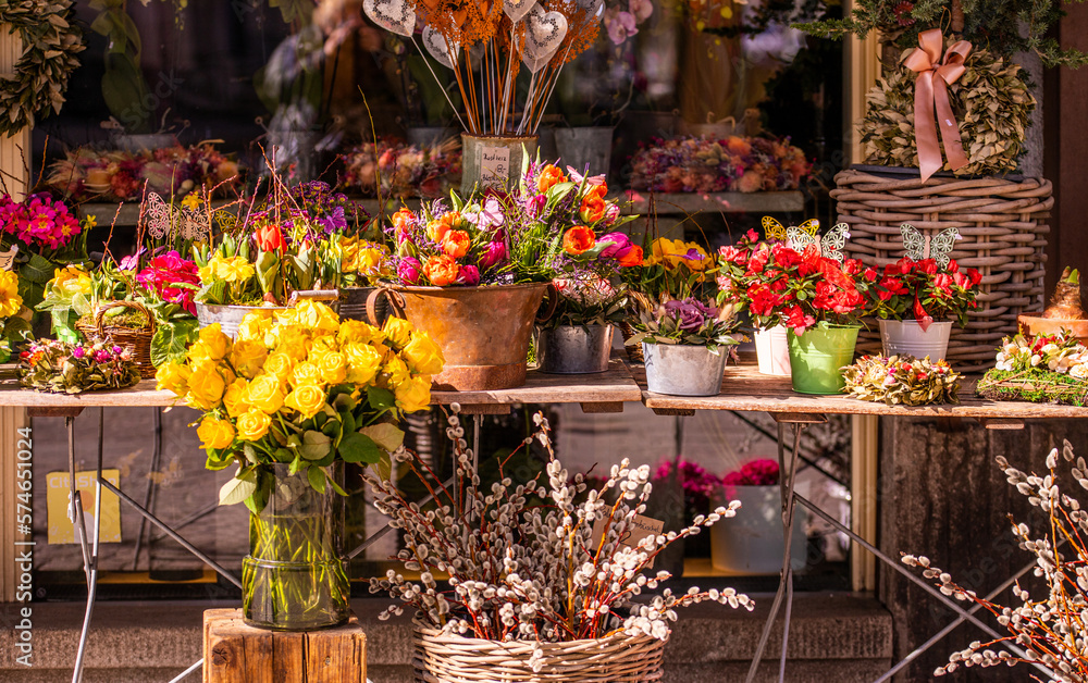 Different flowers and seedlings near the florist flower shop entrance, spring time, easter concept