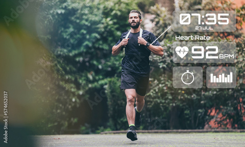 Man running in the park. Healthy runner with smart fit watch. Technology, training, health concept.