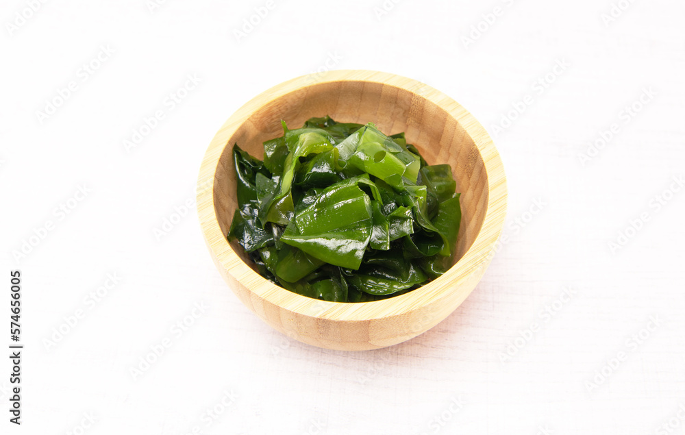 Laminaria (Kelp) seaweed wakame in wooden bowl. Japanese healthy food. Laminaria (Kelp) seaweed wakame in wooden bowl. Japanese healthy food.