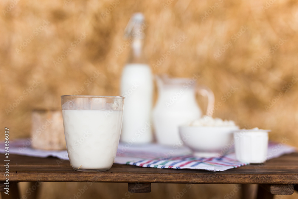 dairy products on table against the background of hay