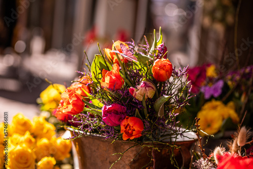Canvas Print Different flowers and seedlings near the florist flower shop entrance, spring ti