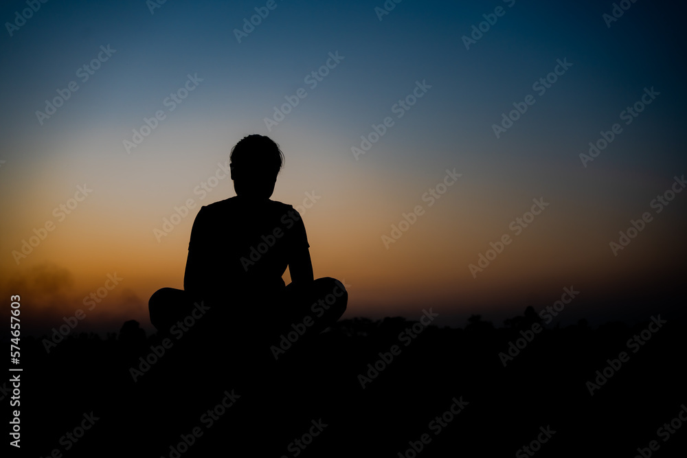 Silhouette of a woman sitdown with so sad in the sunset. Silhouette of a woman sitdown with so sad in the sunset.