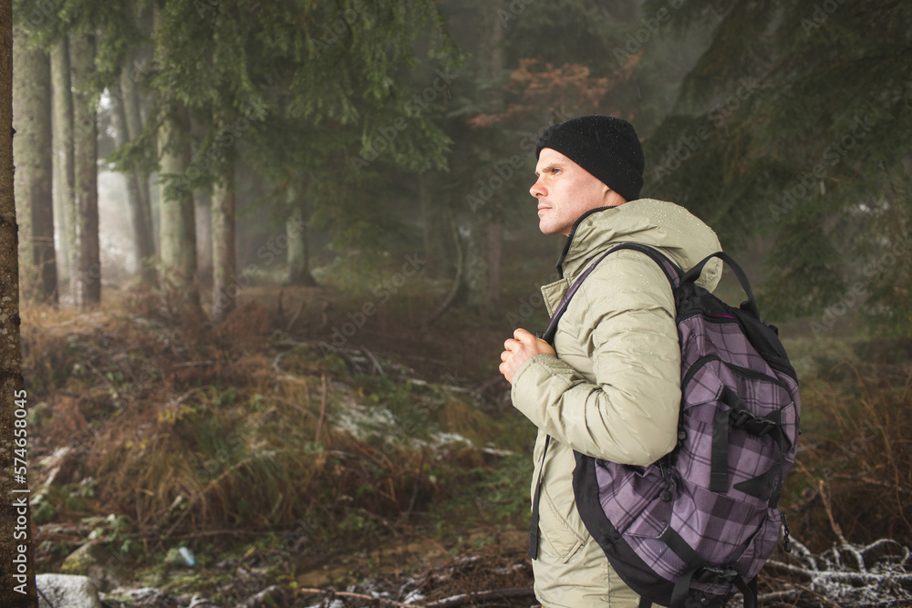 Man in the forest with a backpack