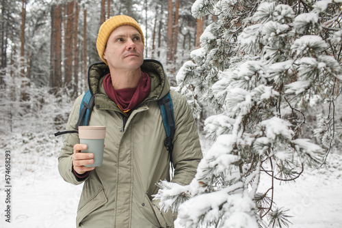 Man in the forest with a thermal mug