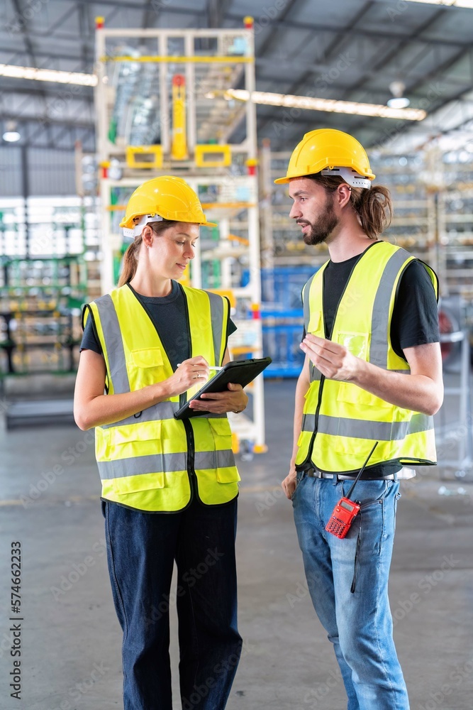 Warehouse worker standing check stock quantity of product and key information to tablet pc Warehouse worker standing check stock quantity of product and key information to tablet pc