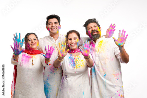 Young indian people showing colors hand and celebrating holi festival.