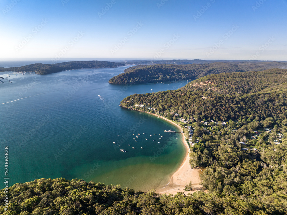 Fototapeta premium Aerial drone view of Great Mackerel Beach and Wharf on the western shores of Pittwater in Ku-ring-gai Chase National Park, Sydney, NSW, Australia. Mackerel can be reached via ferry from Palm Beach.