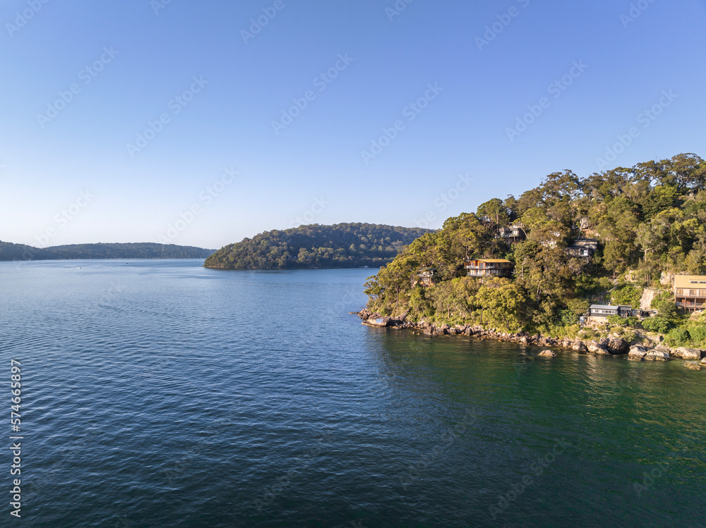 Drone view of holiday homes at Sinclair Point and Soldiers Point (back) near Great Mackerel Beach on the western shores of Pittwater in Ku-ring-gai Chase National Park, Sydney, NSW, Australia.
