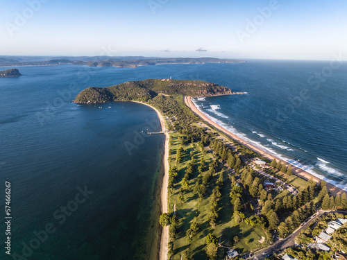 High angle aerial evening drone view of Palm Beach and Barrenjoey Head and Lighthouse. Palm Beach is an affluent beachside suburb in the Northern Beaches region of Sydney, New South Wales, Australia.