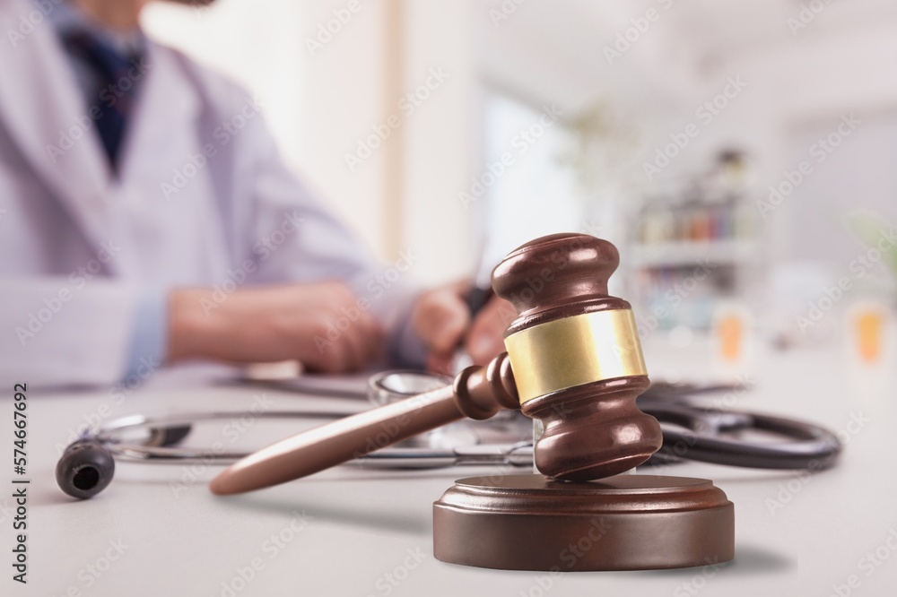 Doctor writing and medical stethoscope on the desk