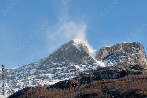 Beautiful landscape of a snowy mountain top with a blue sky and copy space. A streaming peak with frost on a winter afternoon. Peaceful and scenic outdoors with a summit in nature
