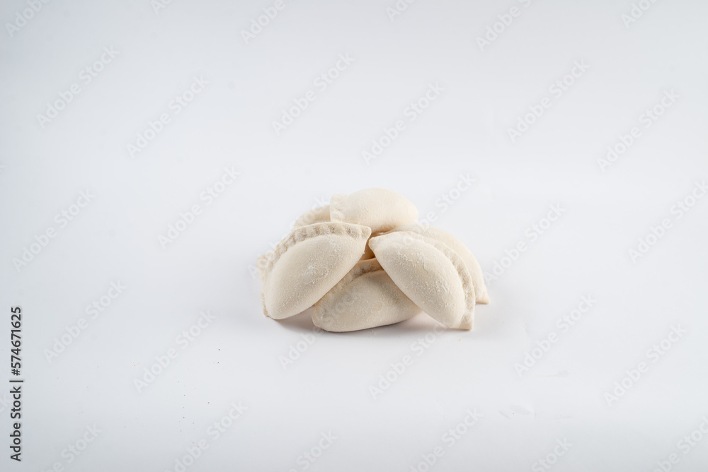 Frozen semi-finished dumplings on a white background Frozen semi-finished dumplings on a white background