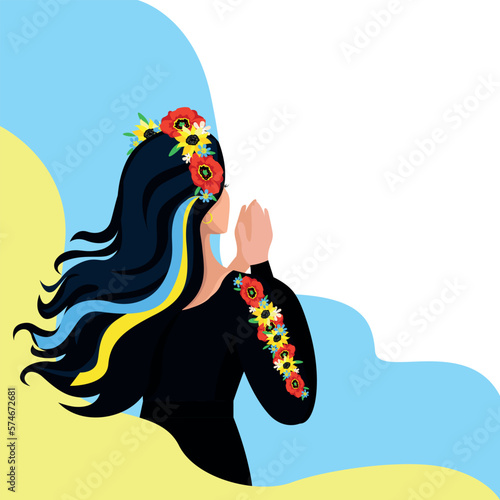 Beautiful Ukrainian woman in national clothes folded her hands for prayer against the background of the Ukrainian flag. Stop the war. Support Ukraine. Pray for Ukraine.
