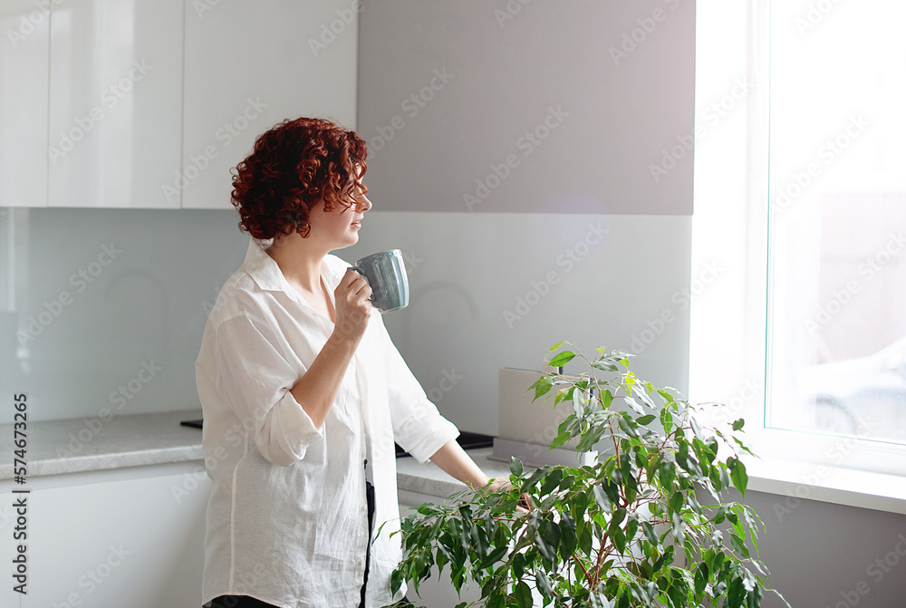 Portrait young woman enjoying a cup of coffee at home. pretty girl drinking hot tea Portrait young woman enjoying a cup of coffee at home. pretty girl drinking hot tea