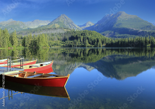 Red boats on mountain lake