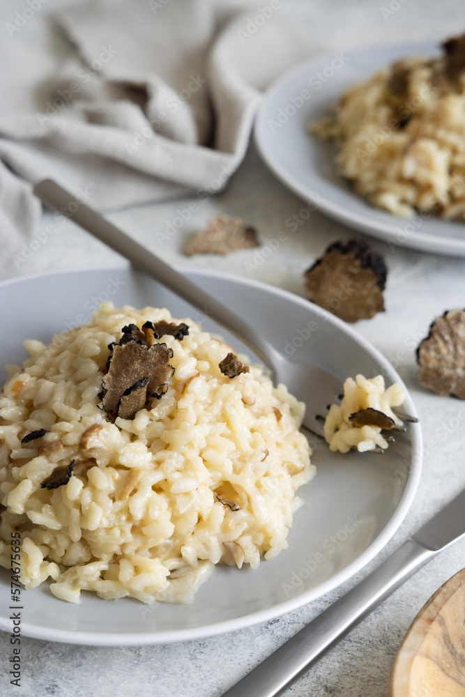 Risotto with porcini mushrooms and black truffles served in a plate top view, gourmet cousine Risotto with porcini mushrooms and black truffles served in a plate top view, gourmet cousine