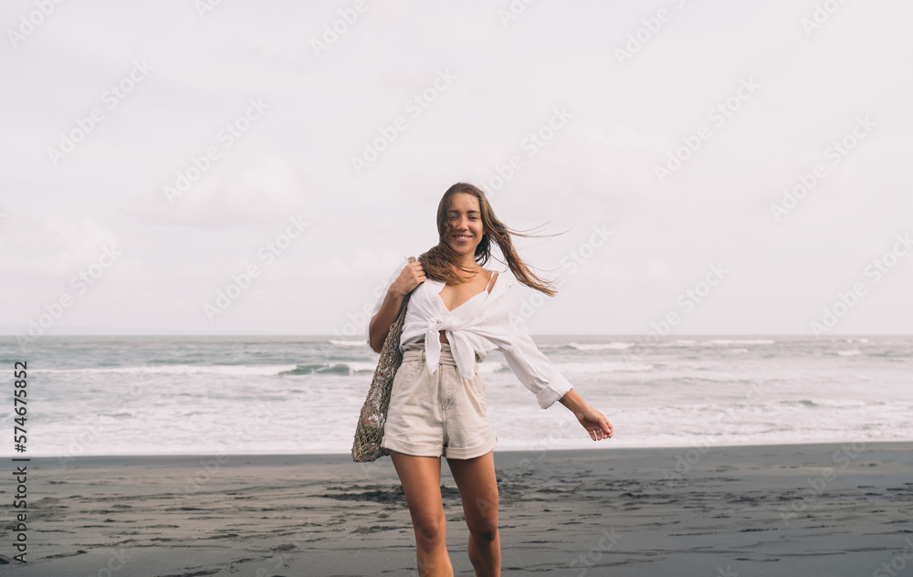 Happy tourist walking on sandy beach