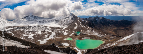 panoramic view of mountains, emerald lakes and blue sky with white clouds in tongarino national park new zealand