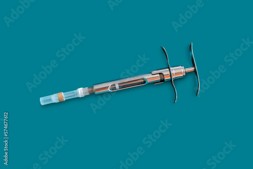 dental anesthesia metal syringe for dental clinics on green background.High quality photo.