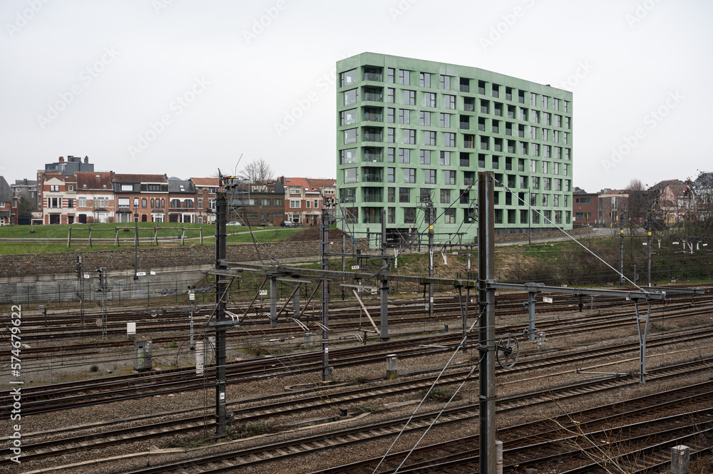 Leuven, Flemish Brabant, Belgium - Railway tracks and green apartment block