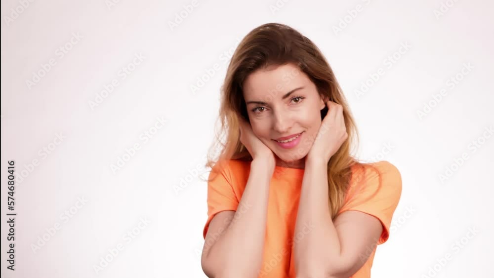 Woman smiling looking at camera. Happy positive emotional blonde girl, long hair. Cheerful lady smile face, beauty self-love concept. Indoors studio, pretty young lady isolated on white background Woman smiling looking at camera. Happy positive emotional blonde girl, long hair. Cheerful lady smile face, beauty self-love concept. Indoors studio, pretty young lady isolated on white background