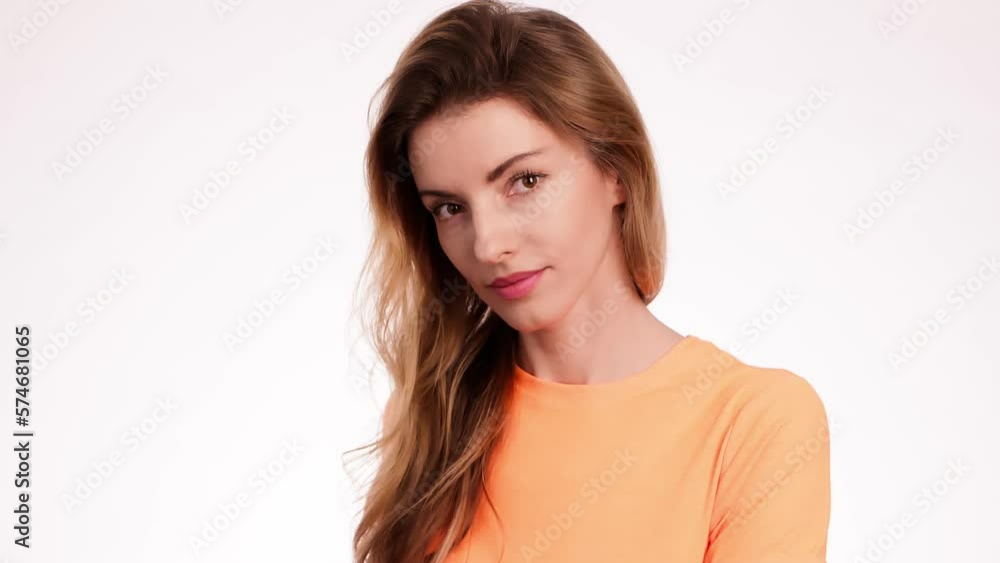 Woman smiling looking at camera. Happy positive emotional blonde girl, long hair. Cheerful lady smile face, beauty self-love concept. Indoors studio, pretty young lady isolated on white background Woman smiling looking at camera. Happy positive emotional blonde girl, long hair. Cheerful lady smile face, beauty self-love concept. Indoors studio, pretty young lady isolated on white background