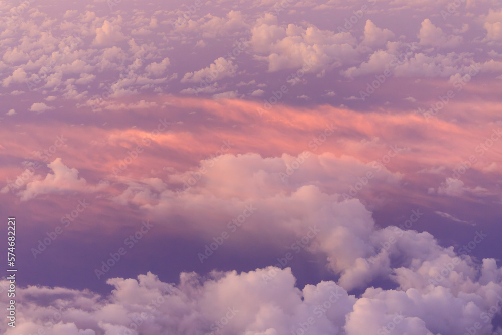 Looking down on pink clouds at sunrise from high elevation - obrazy, fototapety, plakaty 