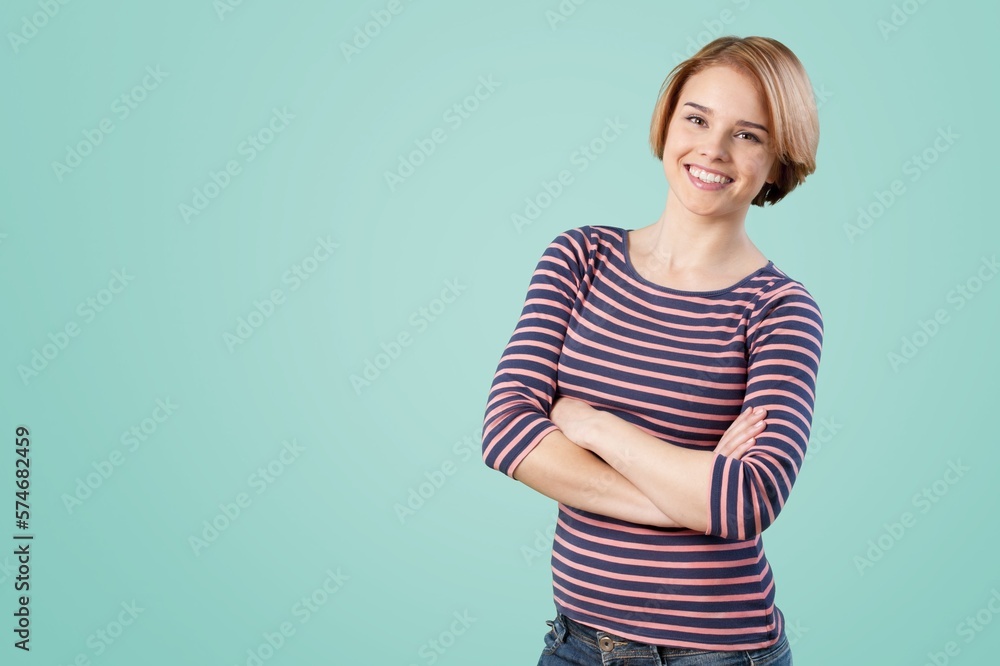 Smiling young woman posing with hands crossed Smiling young woman posing with hands crossed