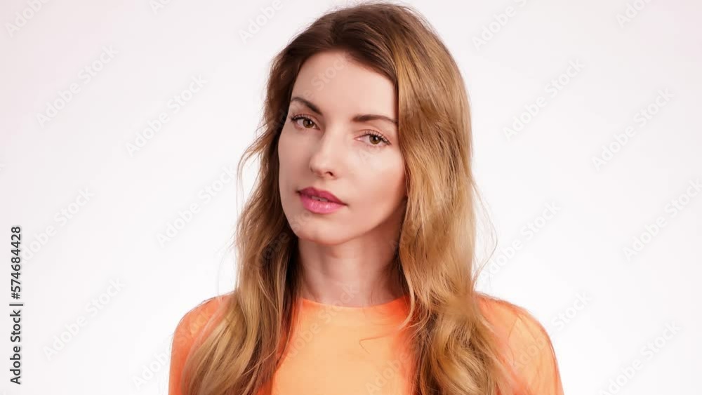 Woman smiling looking at camera. Happy positive emotional blonde girl, long hair. Cheerful lady smile face, beauty self-love concept. Indoors studio, pretty young lady isolated on white background Woman smiling looking at camera. Happy positive emotional blonde girl, long hair. Cheerful lady smile face, beauty self-love concept. Indoors studio, pretty young lady isolated on white background