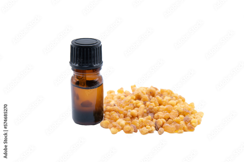 A bottle of frankincense essential oil with frankincense resin, close up shot isolated on white background A bottle of frankincense essential oil with frankincense resin, close up shot isolated on white background