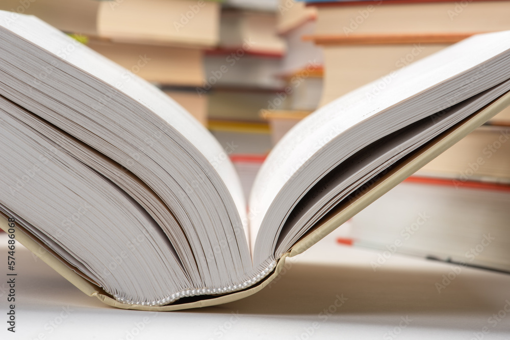 Naklejka premium Opened book in library close-up
