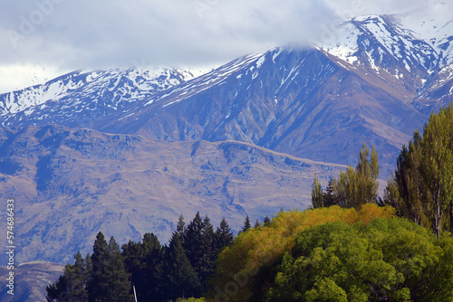 The Southern Alps in Central Otago, New Zealand, beautiful snowy mountains with colourful autumn forests. In South Island, New Zealand