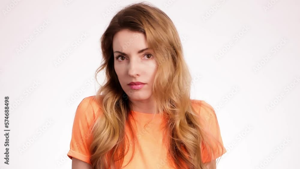 Woman gesturing nodding no, stop, expressing disagreement. Body language concept. Blonde serious girl screaming showing no way ignore, way prohibited in studio isolated on white background. Woman gesturing nodding no, stop, expressing disagreement. Body language concept. Blonde serious girl screaming showing no way ignore, way prohibited in studio isolated on white background.