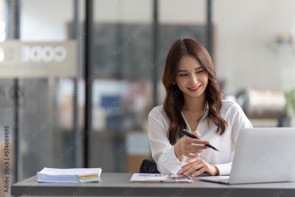 Business woman working on laptop and working at office desk at office