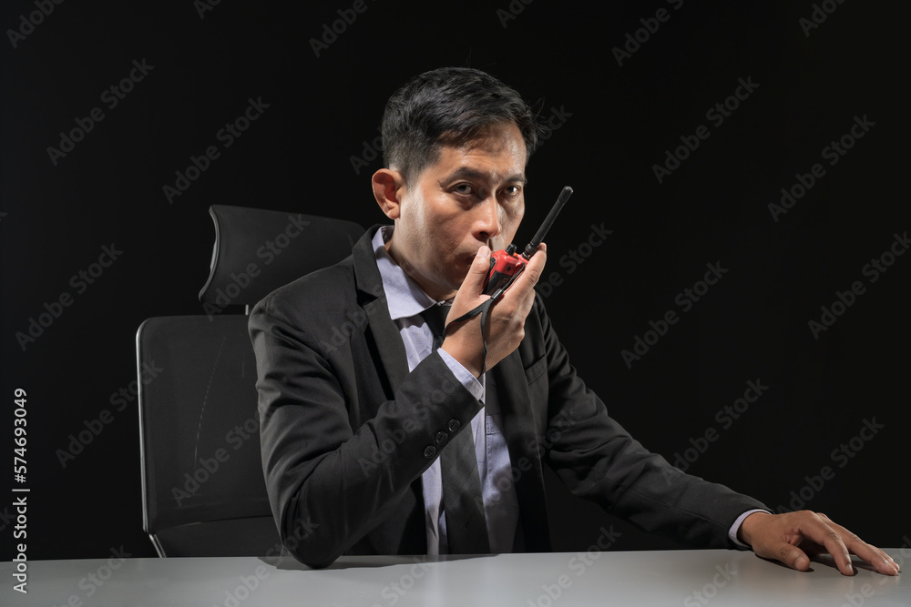 Security guard using portable radio transmitter in control room Security guard using portable radio transmitter in control room