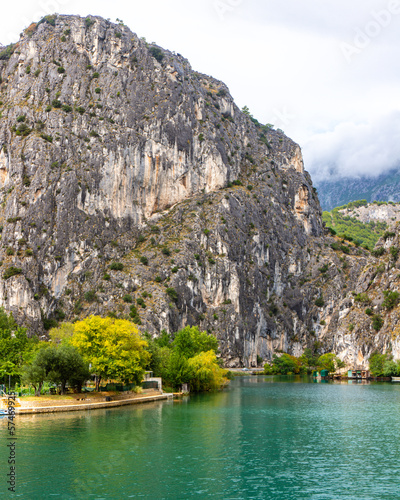 panorama of the town of omis in croatia on the adriatic coast  the famous old town at the mouth of the cetina river  old buildings surrounded by huge mountains in a canyon